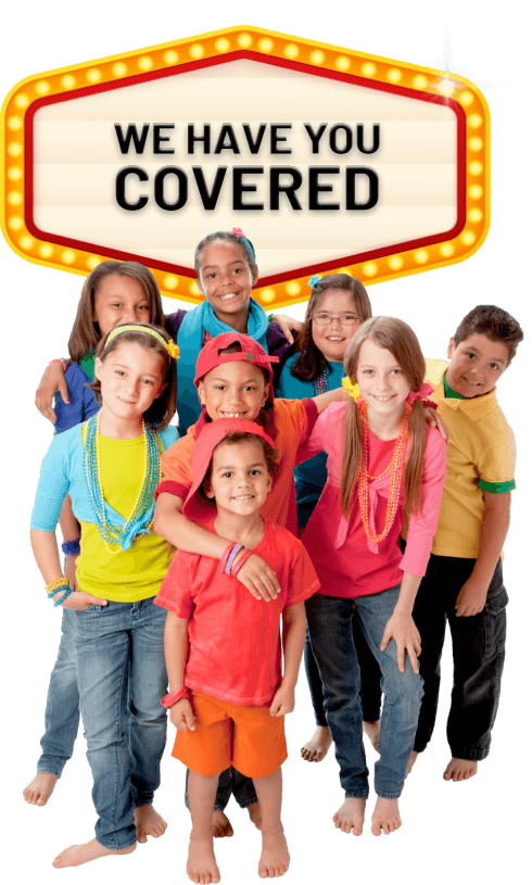Kids posing in front of a lit marquee that says 'we have you covered'